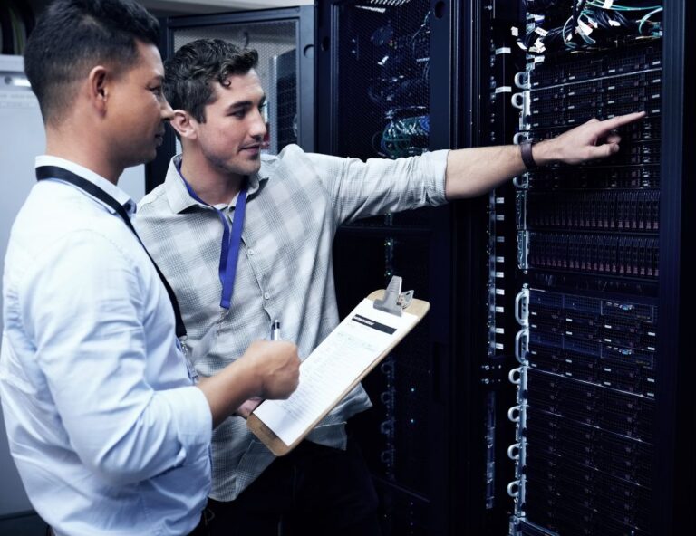 Data center technician walking through server racks, representing contract and full-time workforce models.