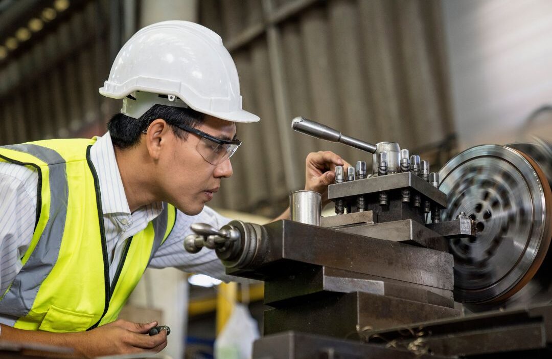 Skilled tradespeople reviewing construction plans inside a mission-critical facility.
