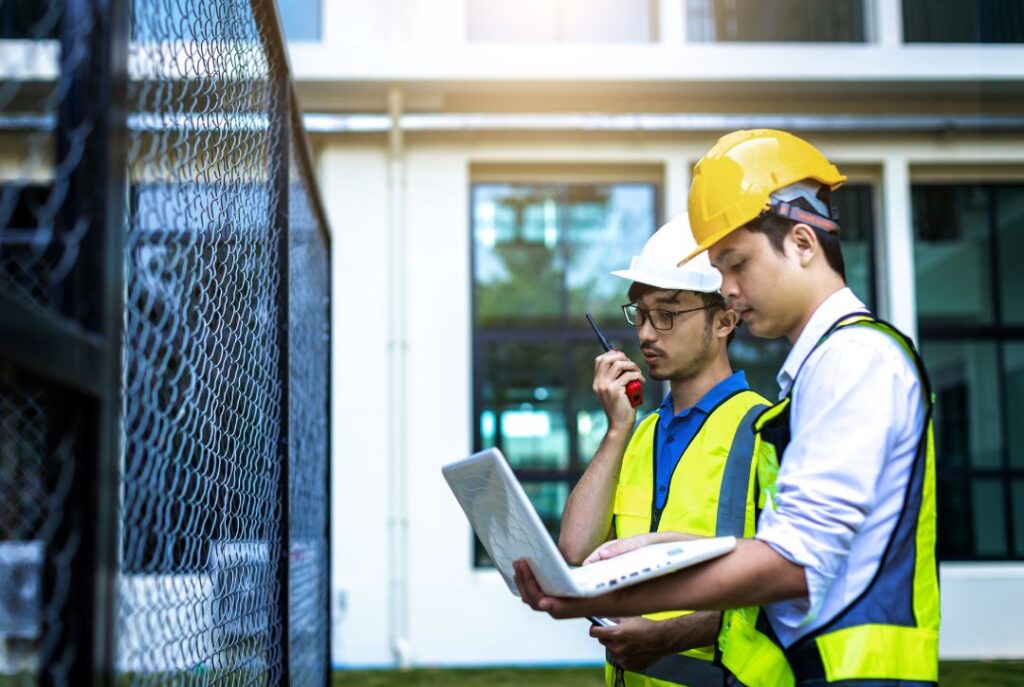 Critical facilities engineers working on electrical infrastructure inside a data center.
