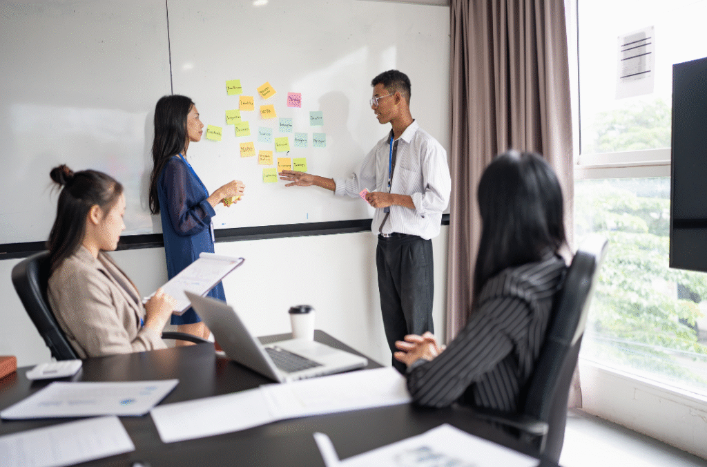 Cross-functional data center engineering team reviewing digital system models.