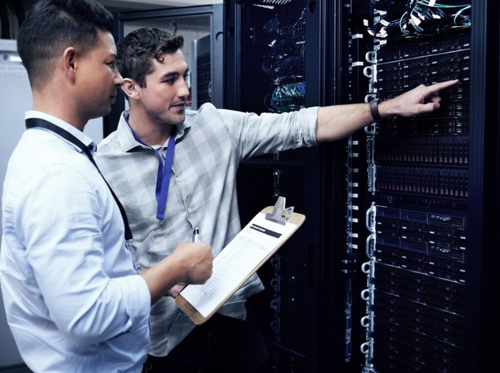 Data center technicians collaborating on critical infrastructure, illustrating long-term workforce retention.